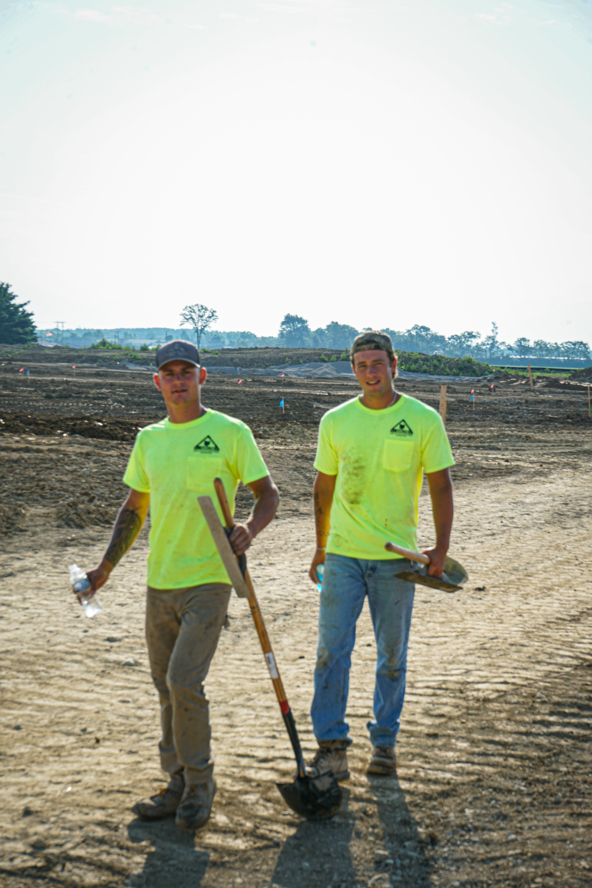two construction workers walking on a site