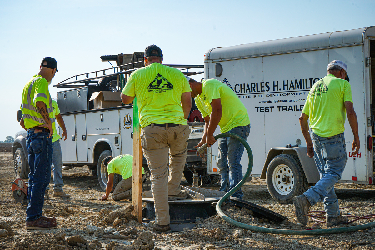 five workers on a construction site