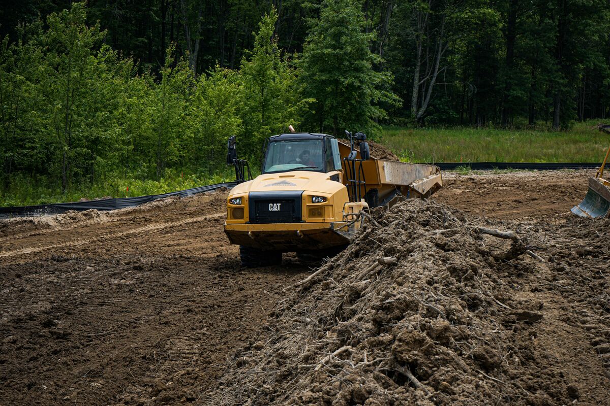 dump truck driving through dirt on construction site