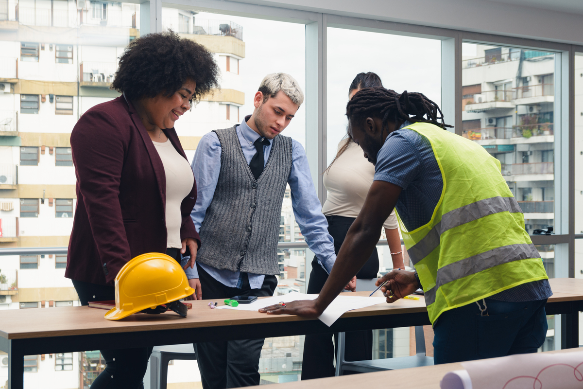 contractor and business people looking over plans